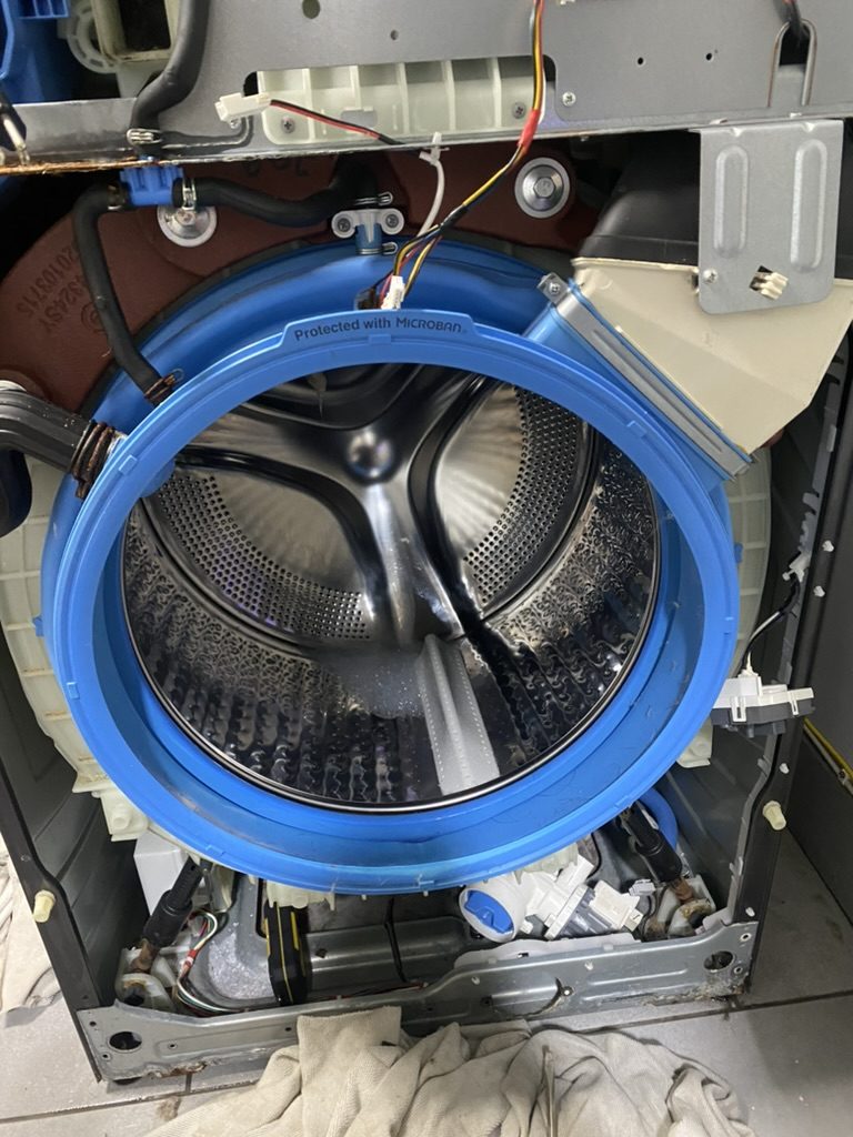 Washer repair with drum and internal components exposed